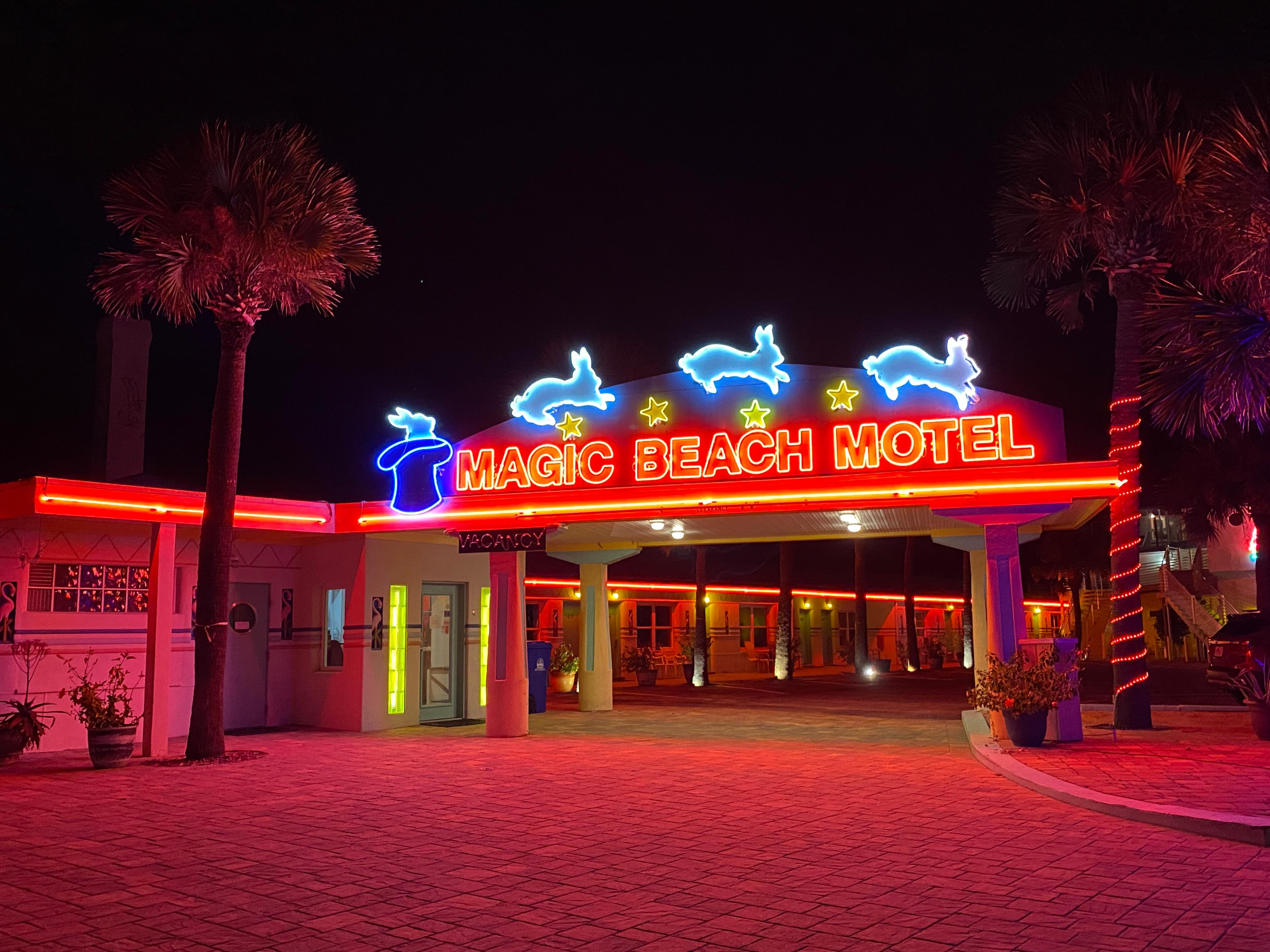 Magic Beach Motel neon sign glowing red and blue at night